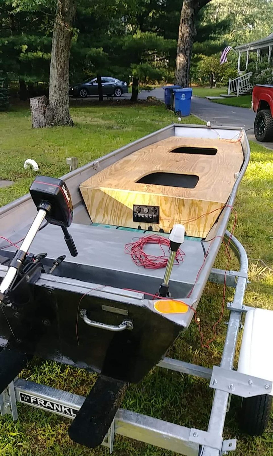 New plywood deck and switch panel test-fit in the driveway, wiring still exposed
